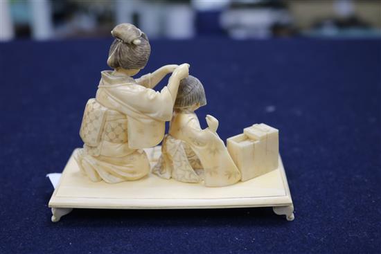 A Japanese figural ivory okimono, width 10cm